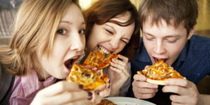 youth eating pizza