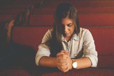 On A Schedule. woman praying wearing a watch. Daily Advent Devotion from Immanuel Lutheran Church in Joplin, Missouri. Call His Name Jesus.