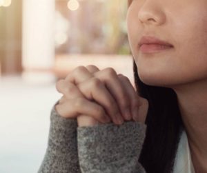 woman praying. LWML Lutheran Women in Mission.